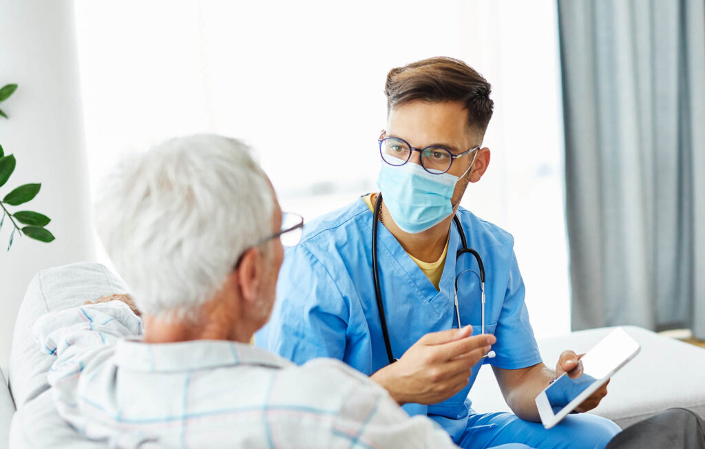 A physiotherapist consulting an elderly man in sydney