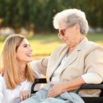 bayside mobile physio sydney team member supporting an enderly woman in a wheelchair
