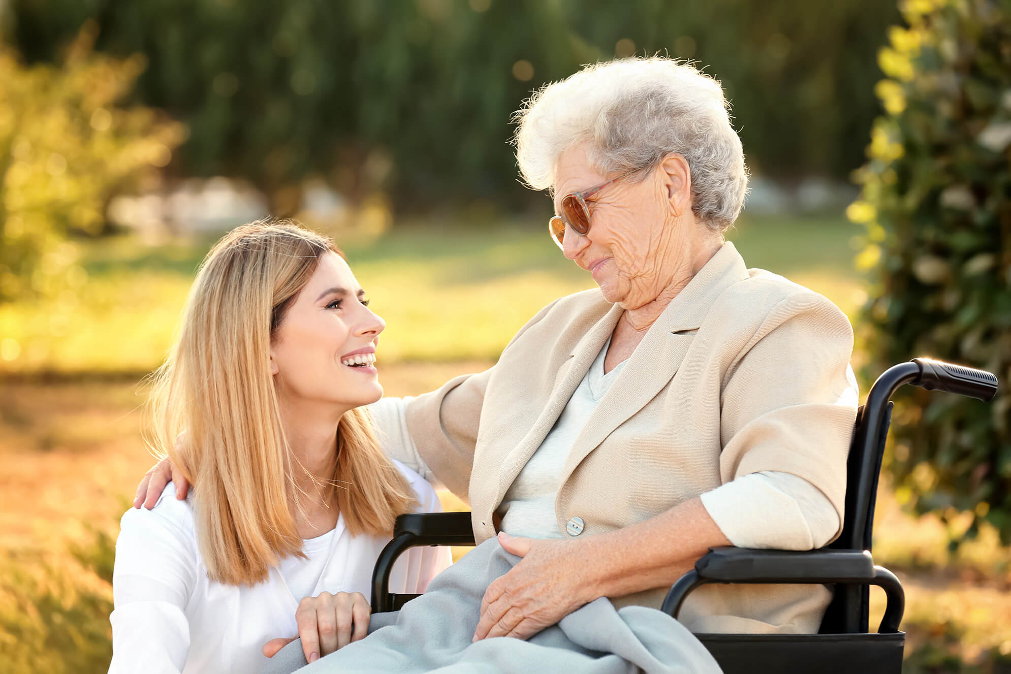 bayside mobile physio sydney team member supporting an enderly woman in a wheelchair