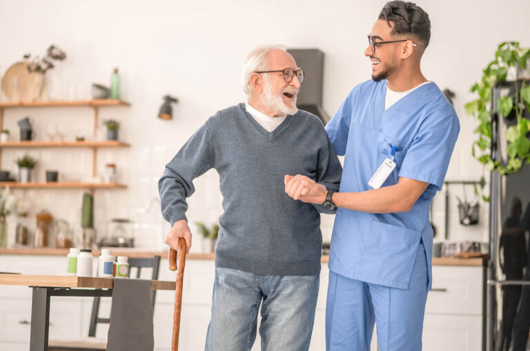 a care giver explaining NDIS Benefits from Regular Physiotherapy to an elderly man at a Home