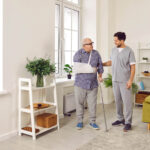 An elderly man exercising to Improve Balance and Prevent Falls with a physiotherapist