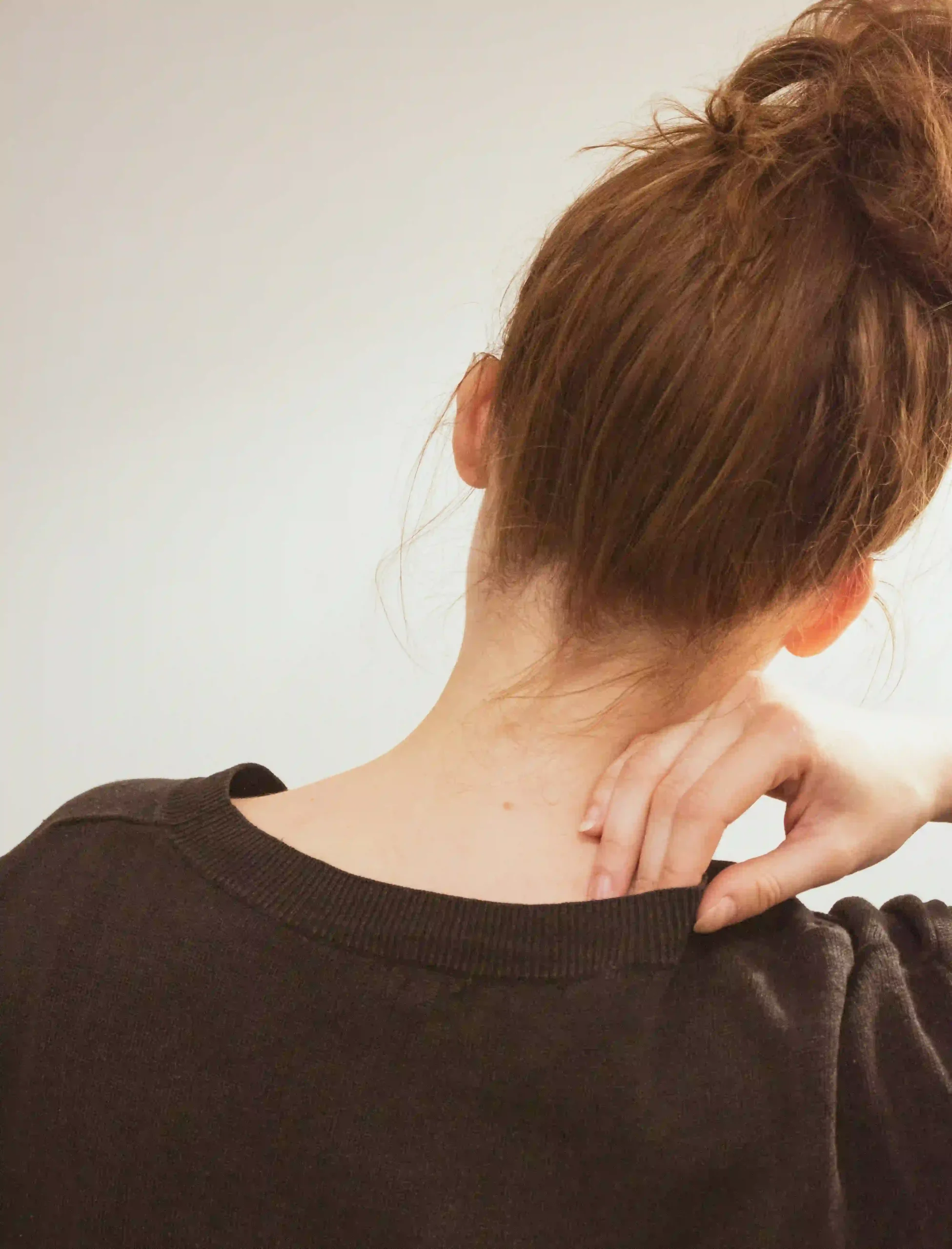 Mobile physiotherapist treating neck pain in a client's home in Sydney