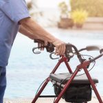 NDIS participant using a wheeled walker outdoors