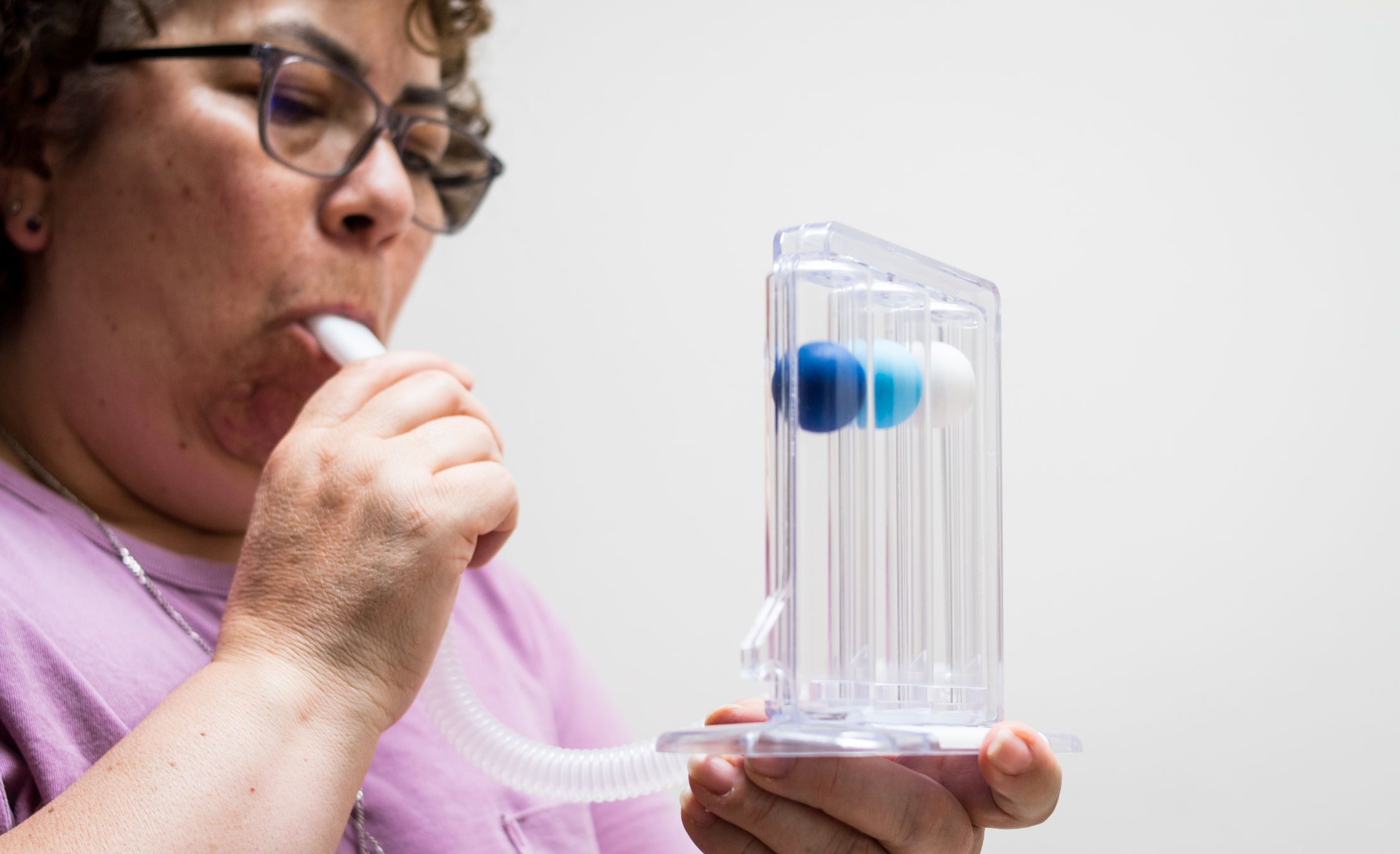 elderly woman doing breathing exercises at home