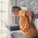 middle aged woman suffering form sciatic back pain