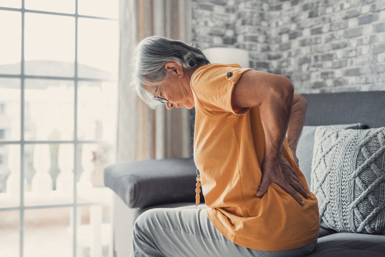 middle aged woman suffering form sciatic back pain