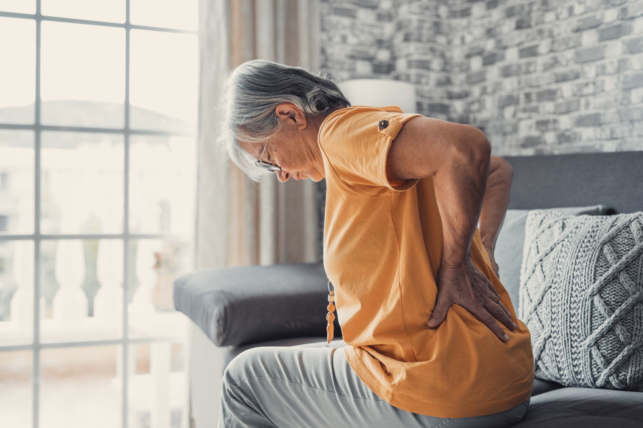 middle aged woman suffering form sciatic back pain
