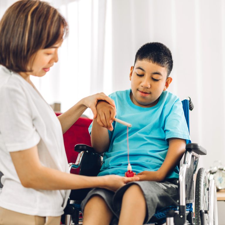 Physiotherapist working with an NDIS participant on a mobility exercise at home