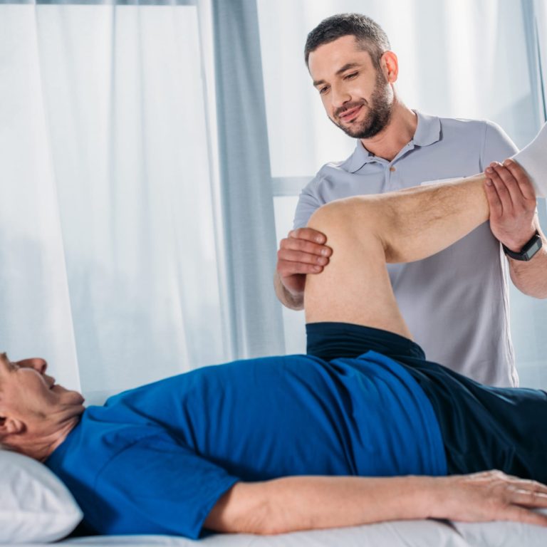 mobile physiotherapist helping patient recover from knee replacement at home in Sydney