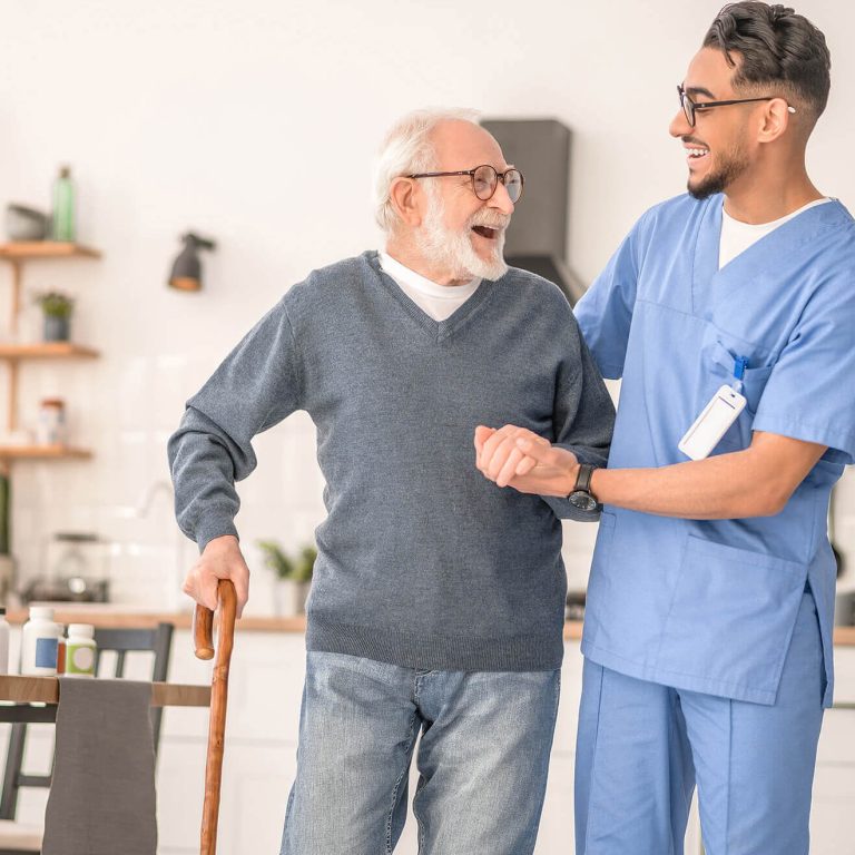 a care giver explaining NDIS Benefits from Regular Physiotherapy to an elderly man at a Home