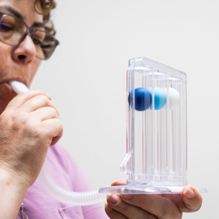 elderly woman doing breathing exercises at home